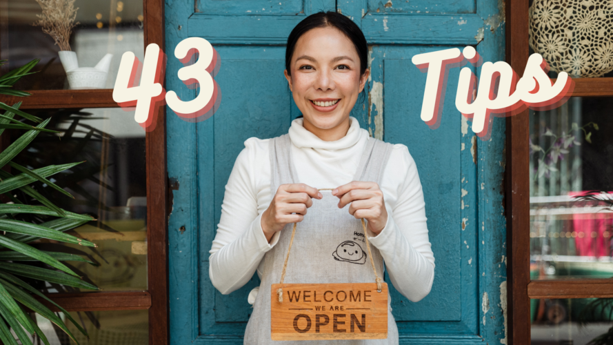 A woman standing with a sign that reads ‘Welcome we are open’. Forty Three TIps written on the image.
